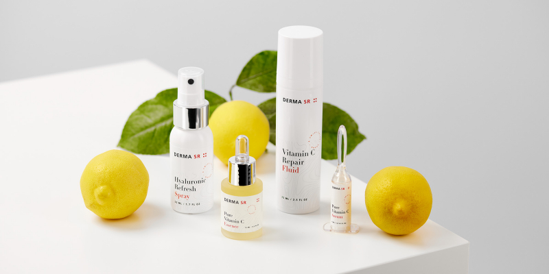 Skin care products and lemons on a white table